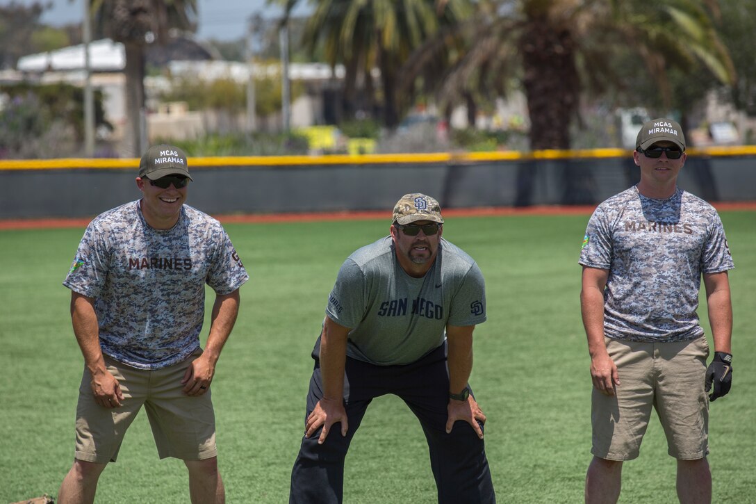 Heath Bell, a San Diego Padres Alumnus, warms up with Marines from Marine Corps Air Station Miramar’s softball team before a game between the San Diego Padres and MCAS Miramar softball team at MCAS Miramar, Calif., May 10. The Padres Alumni came to demonstrate their support for the military with spirited competition and to thank the service members of MCAS Miramar for their service. (U.S. Marine Corps photo by Cpl. Daniel Auvert/Released)