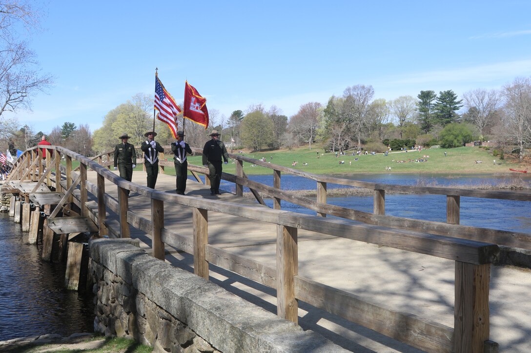 The New England District Ranger Color Guard pass over the Old North Bridge in Concord, Massachusetts during the town’s Patriot’s Day  parade, April 17, 2017.