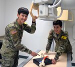 Private Joanna Barton (left) and Private Jaclynn Barton (right) are identical twins who are students in the radiology program at the Medical Education and Training Campus at Joint Base San Antonio-Fort Sam Houston. The twins entered the program in March and are set to graduate in September.