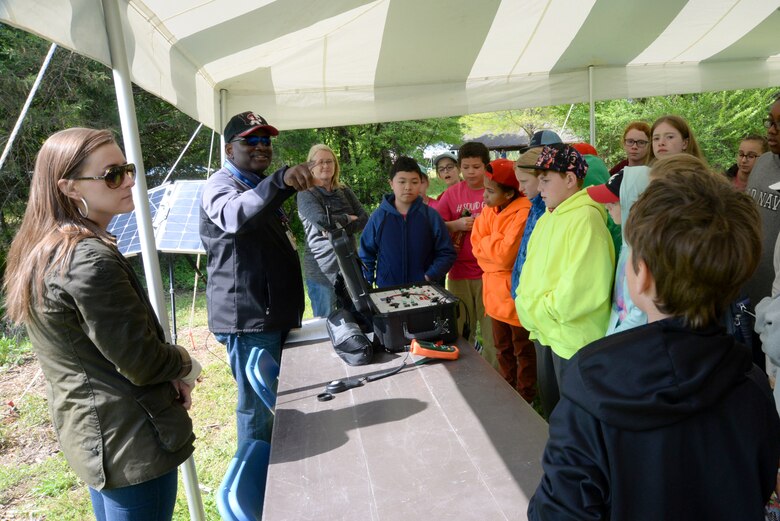Chandler Word, a Department of the Army intern with the Interior Design Branch, left, and Karl Gullatte, a project manager and community planner with the Center’s Engineering Directorate, second from left, field questions from fifth-graders during Redstone Arsenal's Earth Day outdoor educational event April 19, 2018.