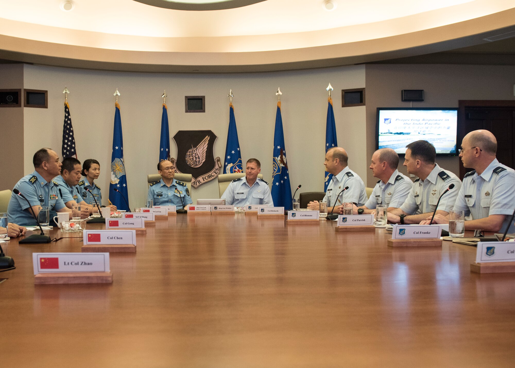 Brig. Gen. Michael Winkler, Pacific Air Forces (PACAF) Strategy, Plans and Programs director and Chinese Maj. Gen. Lan, Deputy Political Commissary/Secretary of Discipline Inspection, People's Liberation Army Air Force (PLAAF) Command College attend a PACAF mission brief at Joint Base Pearl Harbor-Hickam, April 26, 2018.