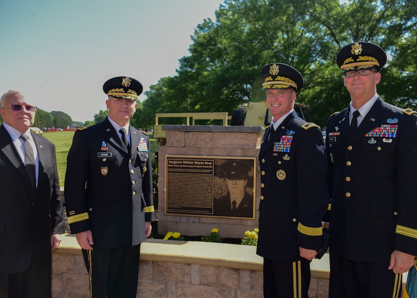 Fort Eustis leaders stand next to a plaque in honor of U.S. Army Sgt. William Wayne Seay at Joint Base Langley-Eustis, Virginia, May 11, 2018. JBLE rededicated Seay Plaza to pay tribute to Vietnam War veterans. (U.S. Air Force photo by Airman 1st Class Monica Roybal)