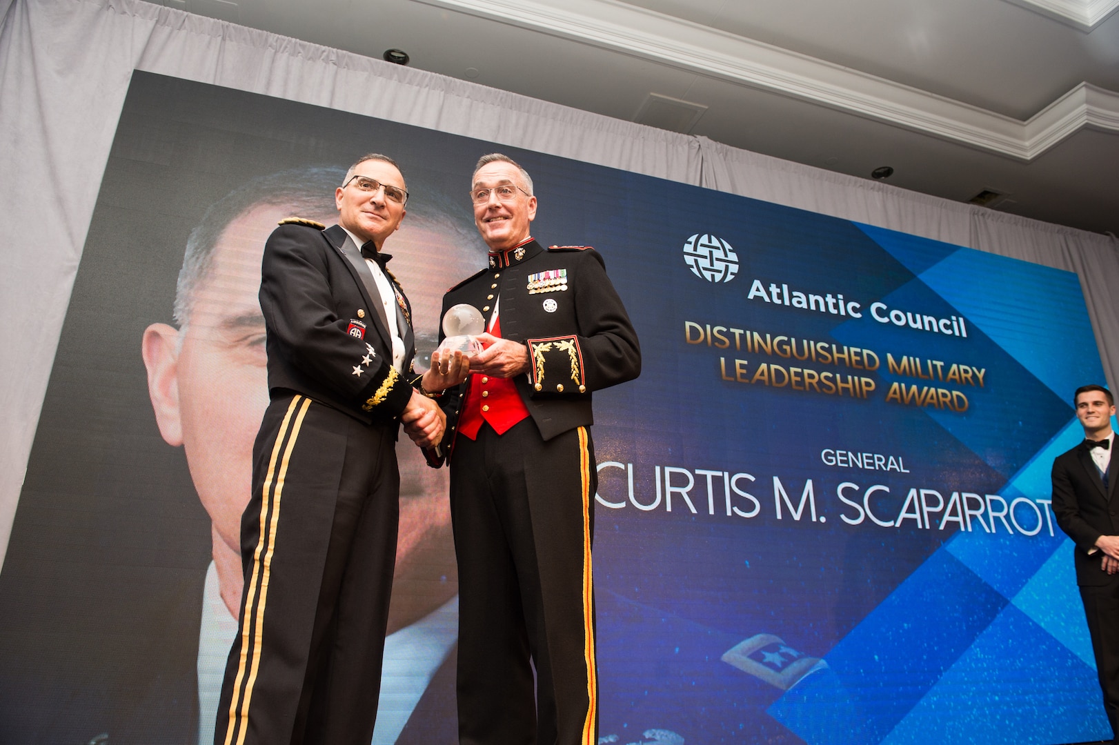 U.S. Marine Corps Gen. Joe Dunford, right, chairman of the Joint Chiefs of Staff, presents the Atlantic Council's Distinguished Military Leadership Award to U.S. Army Gen. Curtis M. Scaparrotti, left, Commander of U.S. European Command and Supreme Allied Commander, Europe; during the council's Distinguished Leaderships Awards dinner in Washington, D.C., May 10, 2018. The awards also recognized former U.S. President George W. Bush, Mr. Howard Schultz, Executive Chairman of Starbucks Corporation; and Ms. Gloria Estefan, Grammy Award-Winning Singer; for embodying the pillars of the transatlantic relationship for their achievement in the fields of politics, military, business, humanitarian, and artistic leadership.