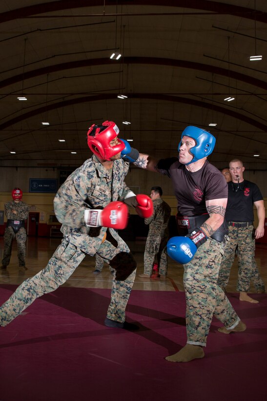 Gunnery Sgt. Justin Kratzer, Radio Maintenance Chief, delivers what looks to be a devestating to blow to Cpl. Jacob Brown, administrative clerk, during the controlled sparring phase of their 3-week long Martial Arts Instructors Course (MAIC) aboard Marine Corps Logistics Base Barstow, Calif., May 10.