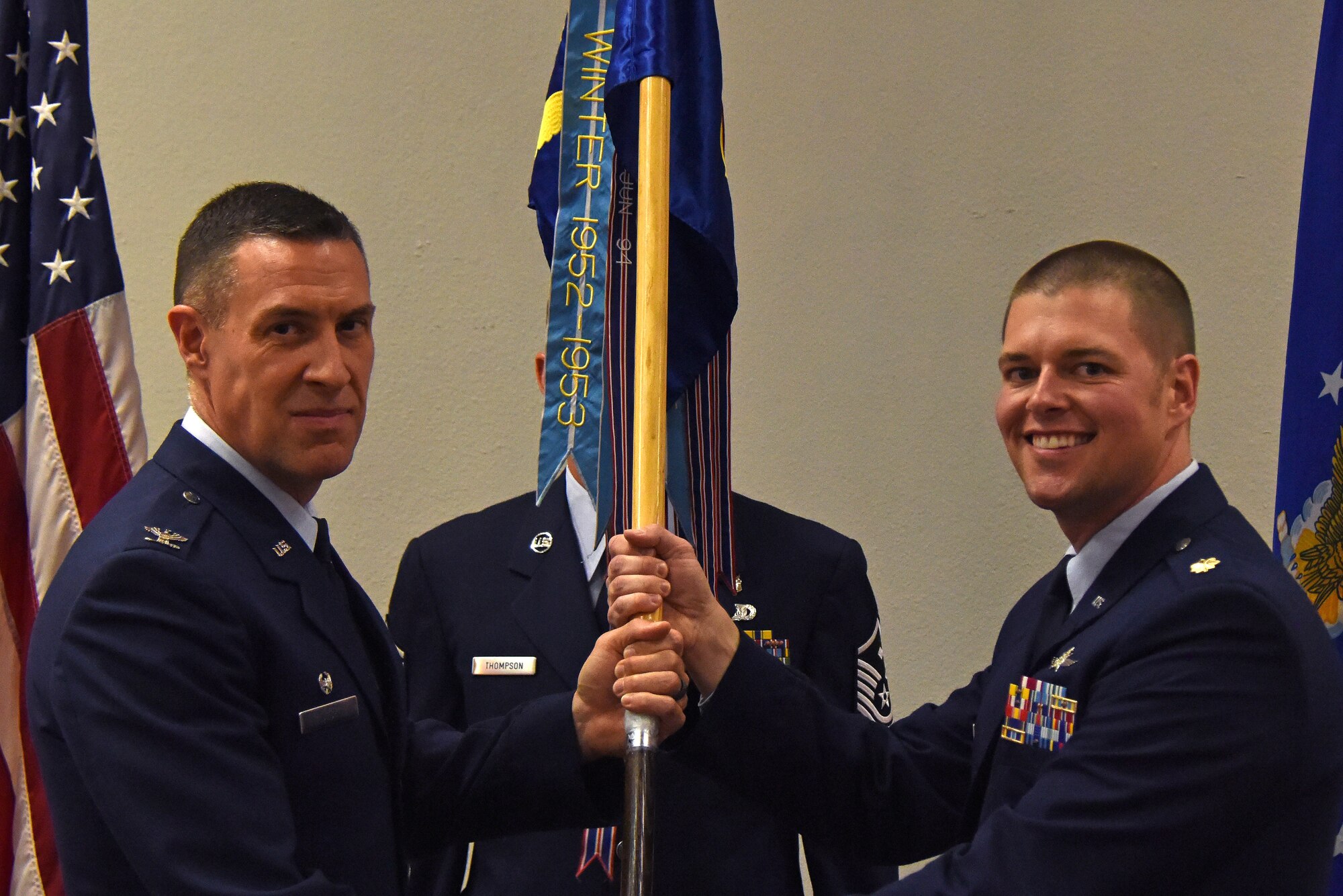 U.S. Air Force Col. Jason Beck, 17th Mission Support Group commander, presents the guideon to Maj. David Coté, 17th Communications Squadron commander, during the change of command ceremony in the Event center on Goodfellow Air Force Base, Texas, May 10, 2018. The change of command ceremony is a time honored military tradition that signifies the orderly transfer of authority. (U.S. Air Force photo by Airman 1st Class Zachary Chapman/Released)