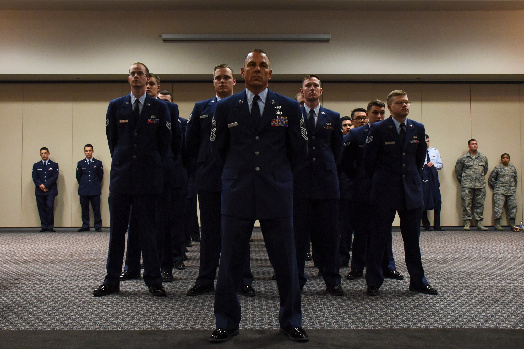 U.S. Air Force Chief Master Sgt. Frank Lubas, 17th Communications Squadron superintendent, stands with members of 17th CS during the change of command ceremony in the Event Center on Goodfellow Air Force Base, Texas, May 10, 2018. The 17th CS provides cyber operations and support to enable the 17th Training Wing to produce the best Intelligence, Surveillance, and Reconnaissance professionals and firefighters in the world. (U.S. Air Force photo by Airman 1st Class Zachary Chapman/Released)