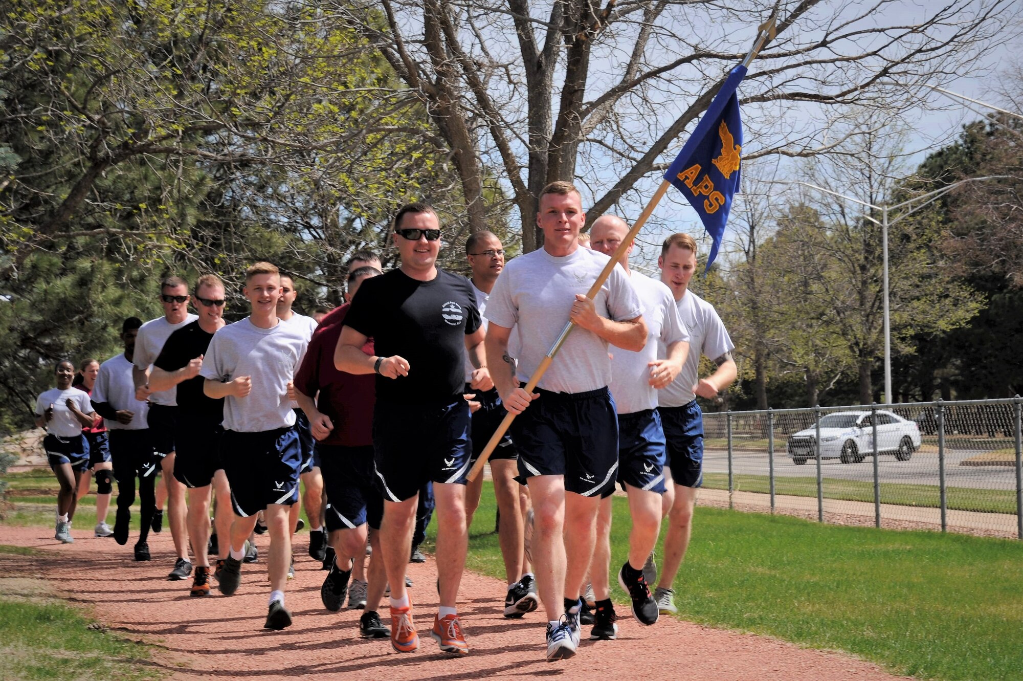 Reservists from the 39th Aerial Port Squadron run in formation during their 4th annual Port Dawg Memorial Run at Peterson Air Force Base, Colorado, May 6, 2018.