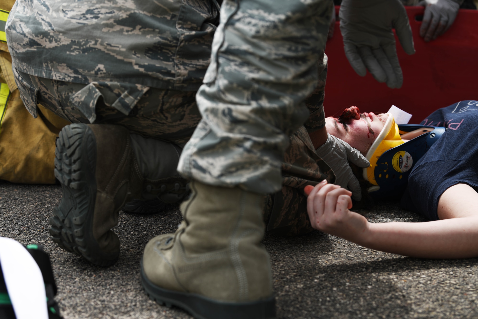 Ellsworth Air Force Base Airmen give medical treatment to a student after a simulated car accident during Freshman Impact at Douglas High School, Box Elder S.D., May 9, 2018. This event teaches young adults about the dangers of driving under the influence and distracted driving so they can make better decisions behind the wheel. (U.S.  Air Force photo by Airman 1st Class Thomas Karol)