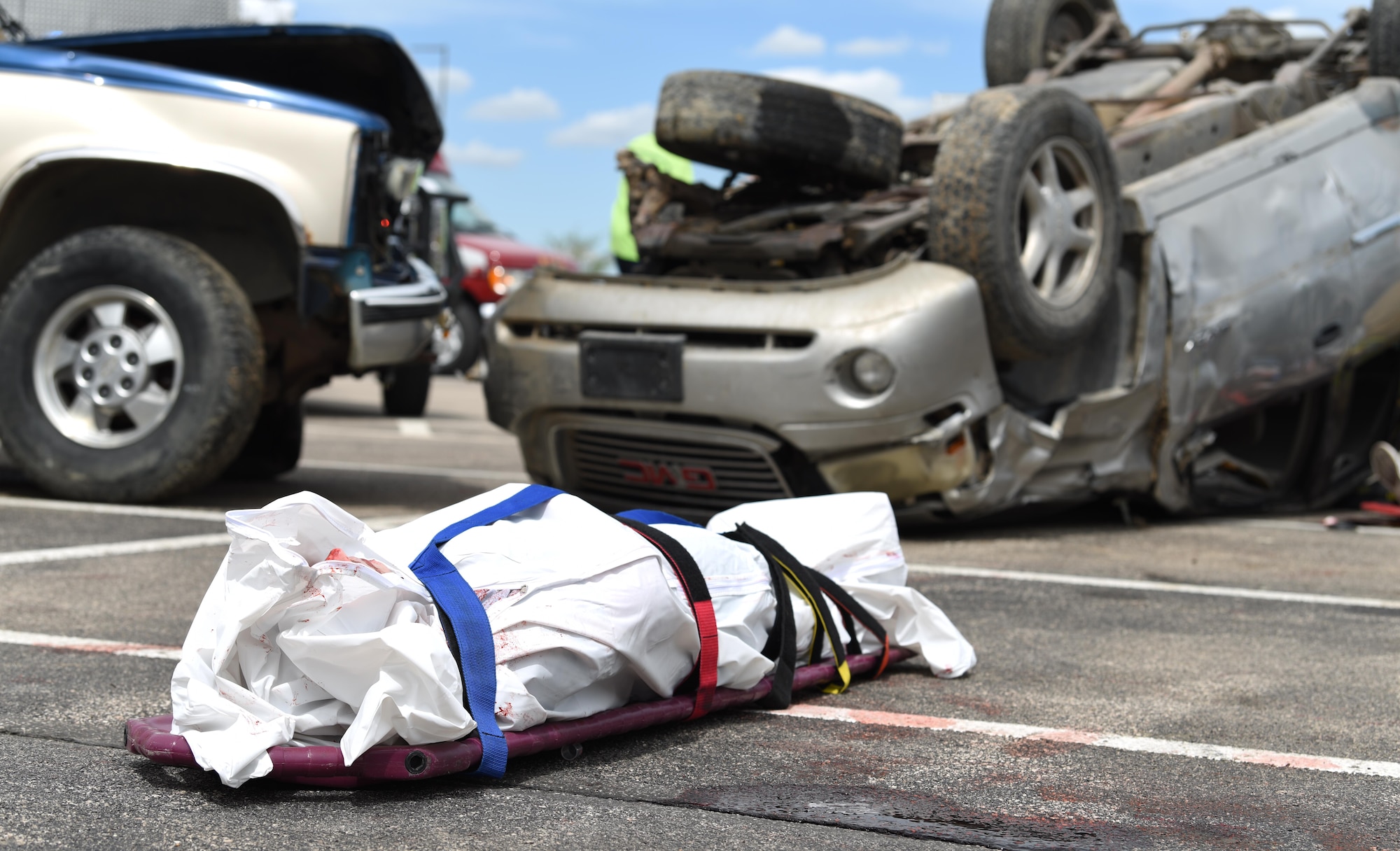 A student performer lays in a body bag during Freshman Impact at Douglas High School, Box Elder S.D., May 9, 2018. This event teaches young adults about the dangers of driving under the influence and distracted driving so they can make better decisions while behind the wheel. (U.S.  Air Force photo by Airman 1st Class Thomas Karol)