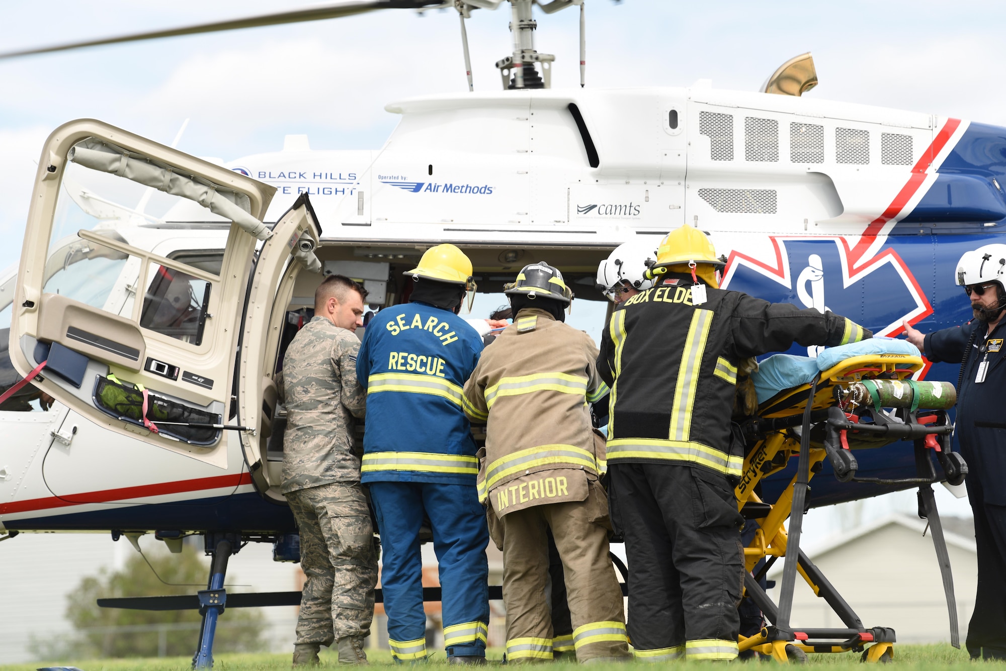 A student performer is loaded in to a medical helicopter during Douglas High School’s Freshman Impact in Box Elder S.D., May 9, 2018. This event teaches young adults about the dangers of driving under the influence and distracted driving so they can make better decisions behind the wheel. (U.S.  Air Force photo by Airman 1st Class Thomas Karol)