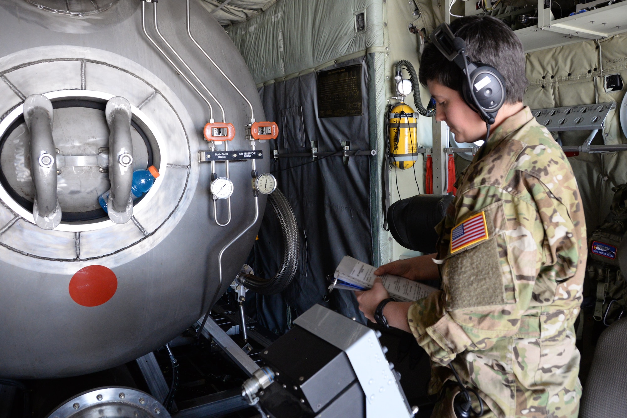 Staff Sgt. Annie Lepillez, a 731st Airlift Squadron loadmaster, reads over a checklist before a training mission during the annual wildland firefighting training and certification sponsored by the U.S.D Department of Agriculture Forest Service at McClellan Reload Base, California, April 26, 2018.