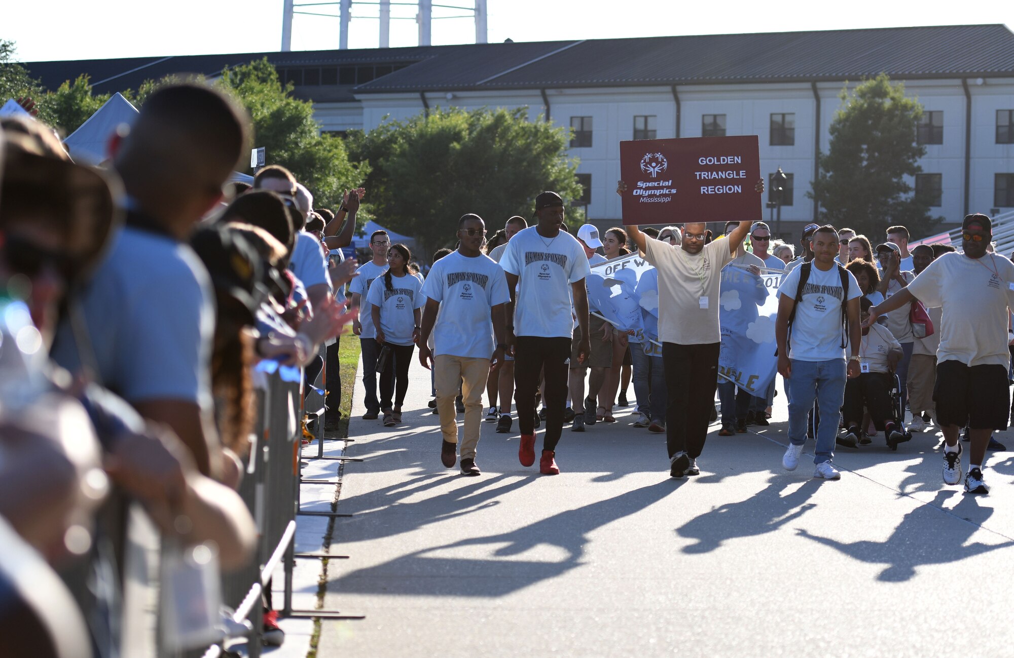 Athletes and Airmen sponsors make their way down the troop walk during the Special Olympics Mississippi 2018 Summer Games opening ceremony at the Training Levitow Training Support Facility drill pad at Keesler Air Force Base, Mississippi, May 11, 2018. Founded in 1968, Special Olympics hosts sporting events around the world for people of all ages with special needs to include more than 700 athletes from Mississippi. (U.S. Air Force photo by Kemberly Groue)