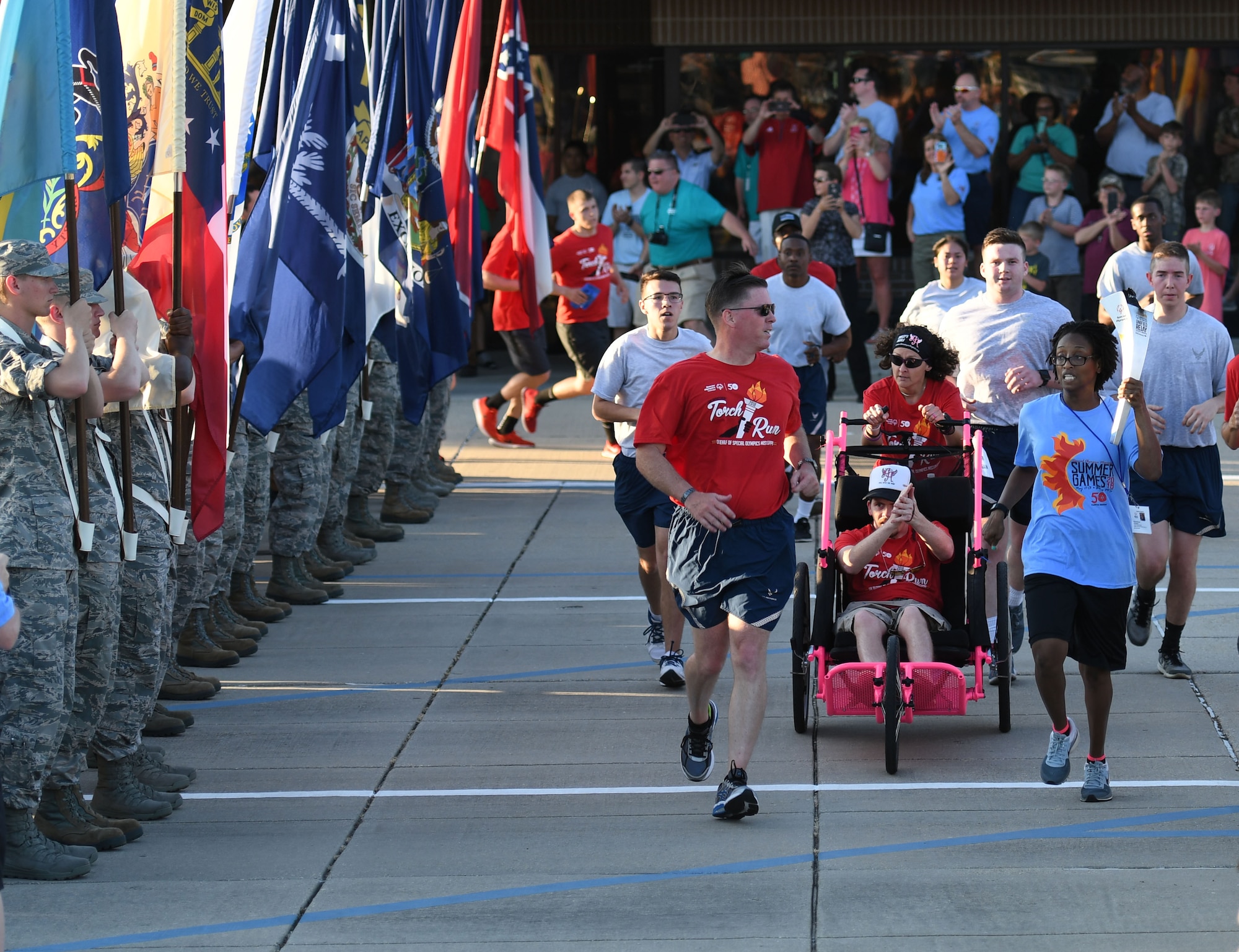 U.S. Air Force Col. C. Mike Smith, 81st Training Wing vice commander, participates in the torch run during the Special Olympics Mississippi 2018 Summer Games opening ceremony at the Training Levitow Training Support Facility drill pad at Keesler Air Force Base, Mississippi, May 11, 2018. Founded in 1968, Special Olympics hosts sporting events around the world for people of all ages with special needs to include more than 700 athletes from Mississippi. (U.S. Air Force photo by Kemberly Groue)