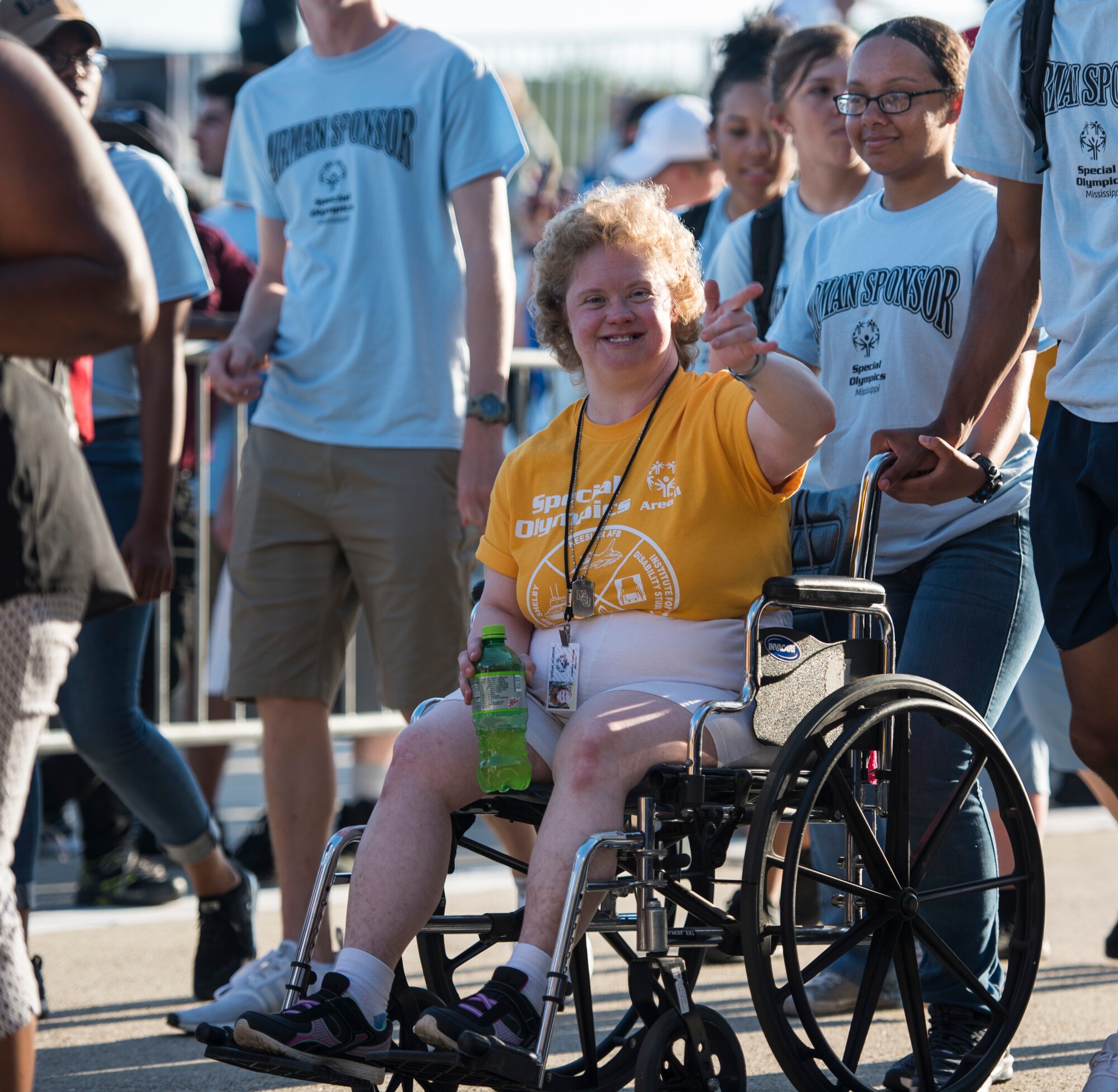 A Special Olympics Mississippi athlete waves during the SOMS 2018 Summer Games opening ceremony at the Levitow Training Support Facility drill pad at Keesler Air Force Base, Mississippi, May 11, 2018. Founded in 1968, Special Olympics hosts sporting events around the world for people of all ages with special needs to include more than 700 athletes from Mississippi. (U.S. Air Force photo by Senior Airman Travis Beihl)