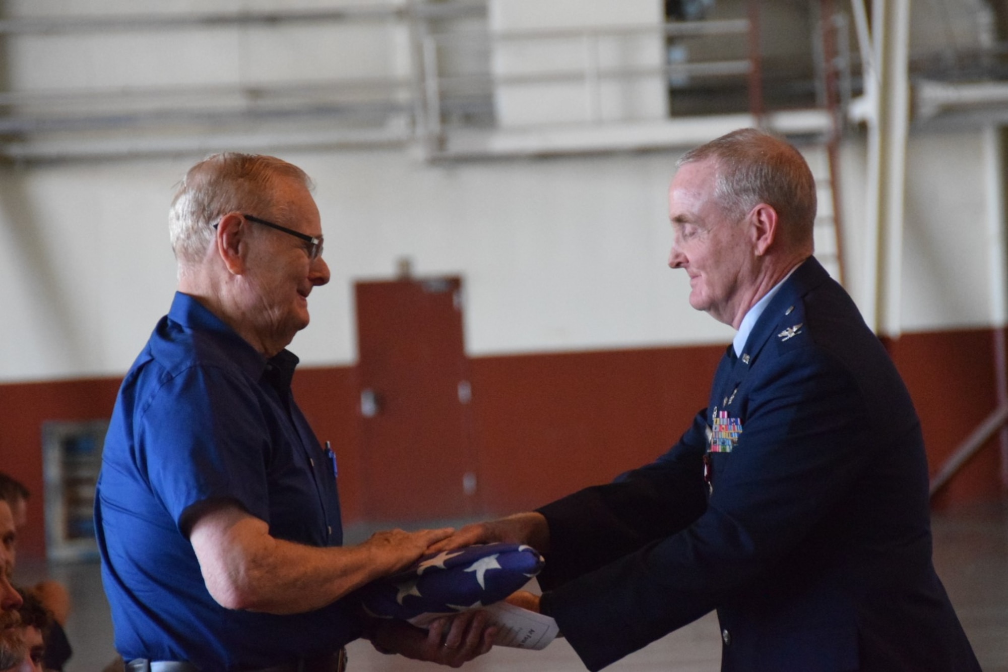 Col. Michael Nelson, 433rd Medical Squadron, pays tribute to his father, Larry Nelson, by giving him the American flag the 433rd Honor Guard had just presented to him at his retirement ceremony May 5, 2018 at Joint Base San Antonio, Texas.  (U.S. Air Force photo by Tech. Sgt. Carlos J. Trevino)