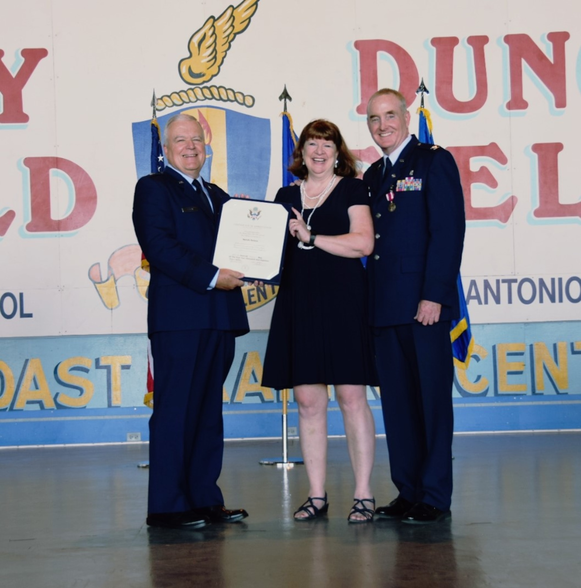 Brig. Gen. John C. Fobian, former 433rd commander, presented Mrs. Sarah Nelson, a spouse certificate of appreciation alongside her husband Col. Michael Nelson, 433rd Medical Squadron commander, May 5, 2018 at Joint Base San Antonio, Texas. Nelson began his Air Force career at Kelly Air Force Base, Texas as an enlisted Airman as a bioenvironmental engineering specialist. (U.S. Air Force photo by Tech. Sgt. Carlos J. Trevino)