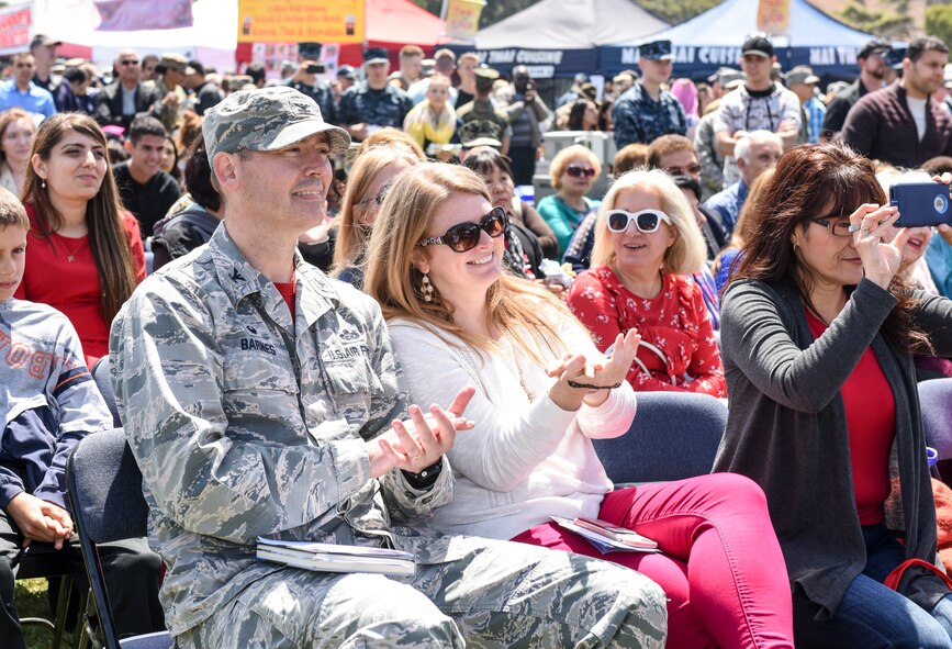 U.S. Air Force Col. Wiley Barnes, 517th Training Group commander, and Andrea Barnes watch performances on the main stage during the  during the Defense Language Institute Foreign Language Center Language Day at the Presidio of Monterey, California, May 11, 2018. The 517th TRG is part of the 17th Training Wing remotely located at the Presidio of Monterey, Calif.