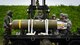 Airmen participating in Combat Ammunition Production Exercise 2018, a combat ammunition production exercise, load a cluster bomb unit on Gwangju Air Force Base, Gwangju, Republic of Korea, May 7, 2018.