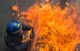 A member of the Police Support Unit is engulfed in flames after being struck with a molotov cocktail, at RAF Alconbury, United Kingdom, May 2, 2018. The strike simulated real world scenarios and taught officers how to overcome the mental and physical effects of fire. (U.S. Air Force photo by Senior Airman Chase Sousa)