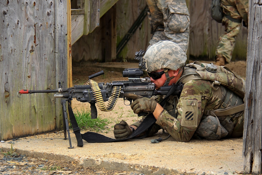 A soldier scans his sector while providing security.