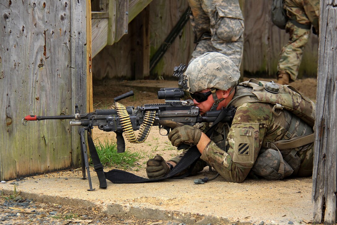 A soldier scans his sector while providing security.