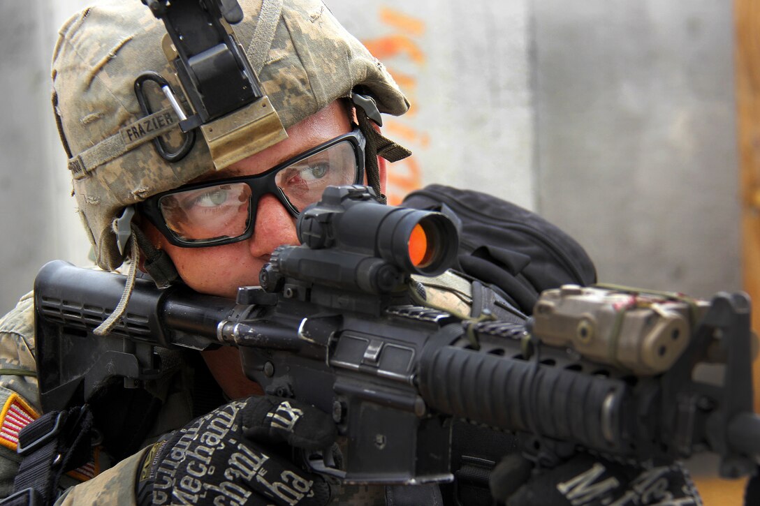 A soldier takes aim while providing security.