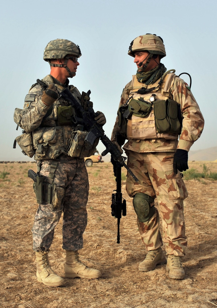 Maj. James Eriksen, left, commander of Operational Mentor and Liasion Team (OMLT) 9.1, talks with a Hungarian army counterpart while on duty in Afghanistan, circa 2009. The ONG and Hungarian military partnered for several rotations in the early 2010s to train the Afghan National Army.