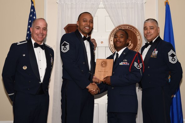 U.S. Air Force Staff Sgt. Leon Brown, 50th Attack Squadron, receives the Senior Master Sgt. David B. Reid Airman Leadership School (ALS) Commandant’s Award during the ALS Class 18-4 graduation ceremony at Shaw Air Force Base, S.C., May 10, 2018.