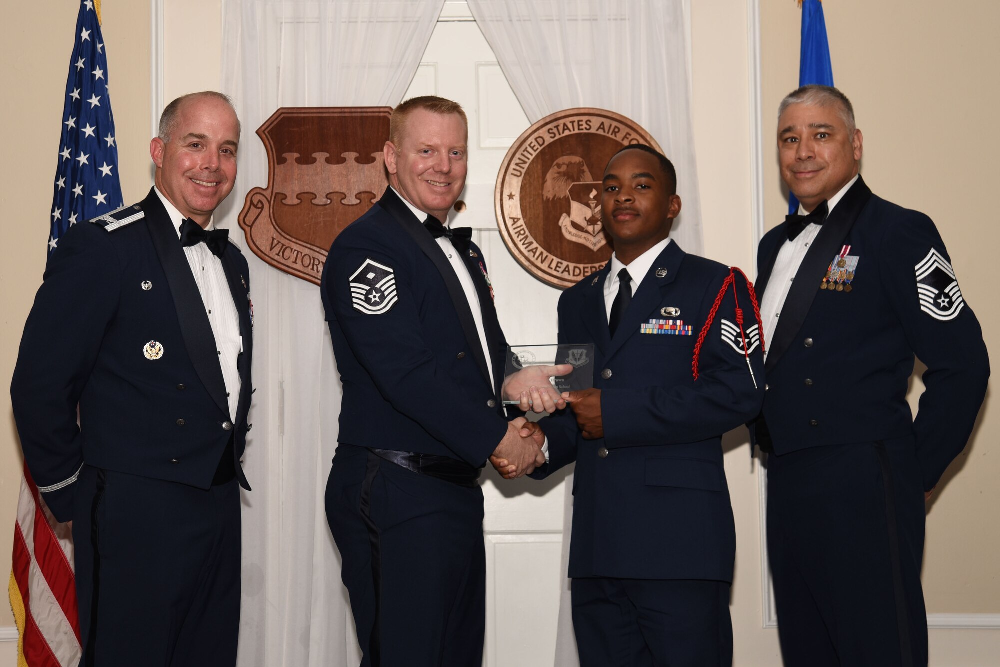 U.S. Air Force Staff Sgt. Leon Brown, 50th Attack Squadron, receives a distinguished graduate award for Class 18-4 of the Senior Master Sgt. David B. Reid Airman Leadership School, at Shaw Air Force Base, S.C., May 10, 2018.