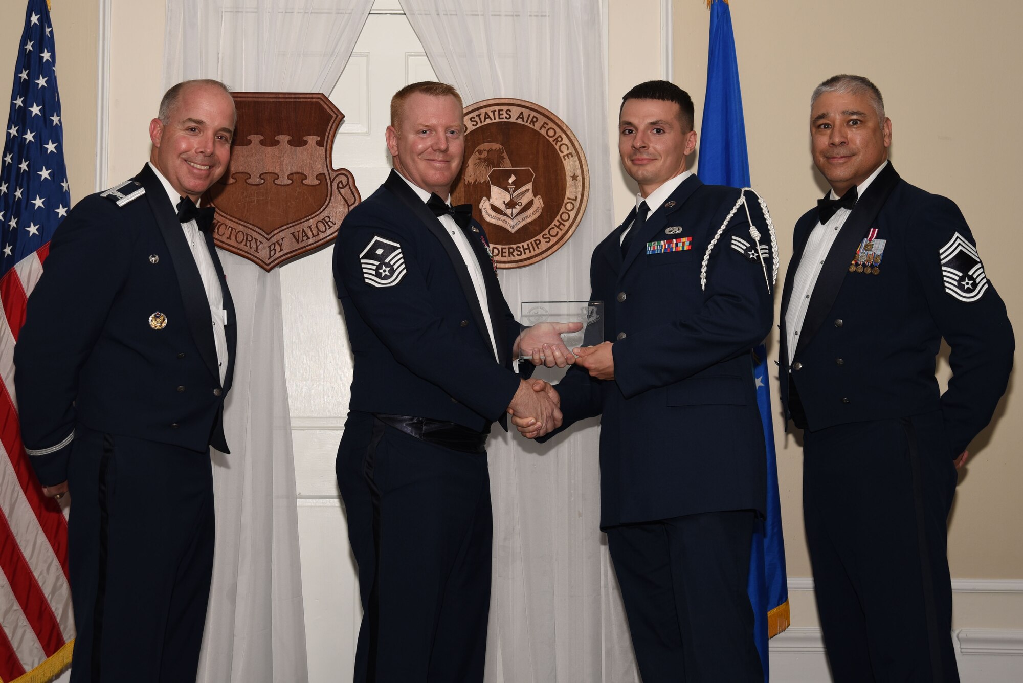 U.S. Air Force Senior Airman John Kotash, 20th Aircraft Maintenance Squadron, receives a distinguished graduate award for Class 18-4 of the Senior Master Sgt. David B. Reid Airman Leadership School, at Shaw Air Force Base, S.C., May 10, 2018.
