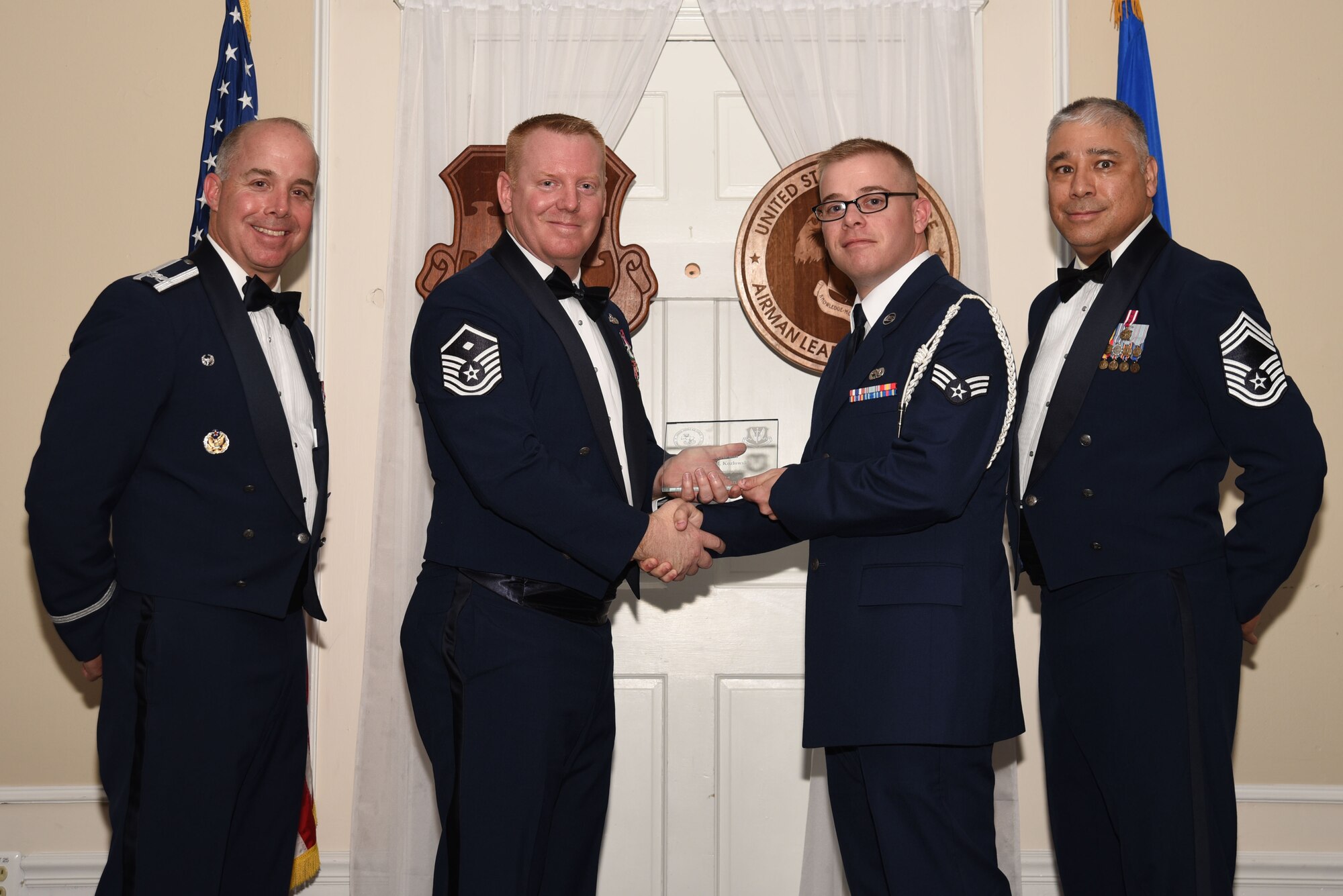 U.S. Air Force Senior Airman Jordan Kozlowski, 20th Equipment Maintenance Squadron, receives a distinguished graduate award for Class 18-4 of the Senior Master Sgt. David B. Reid Airman Leadership School, at Shaw Air Force Base, S.C., May 10, 2018.