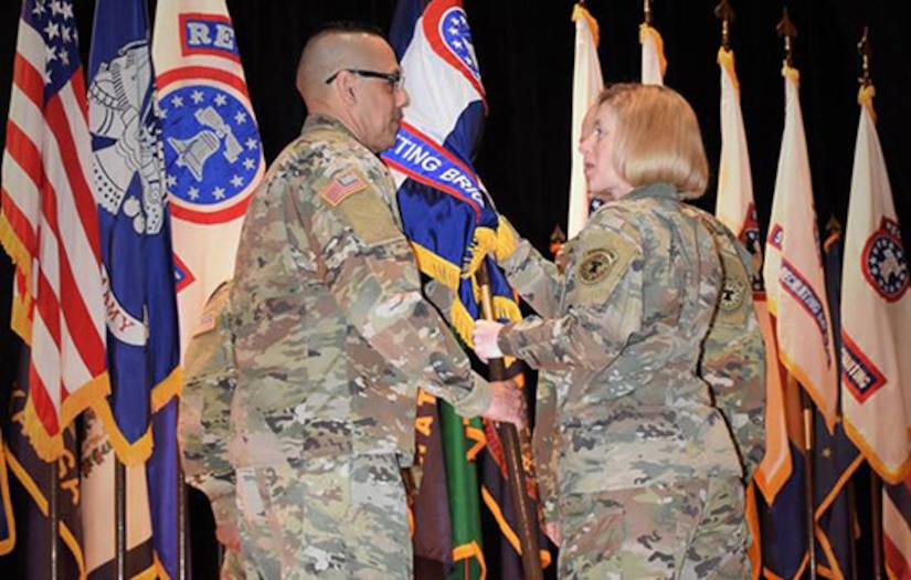 two soldiers exchanging the unit guide on