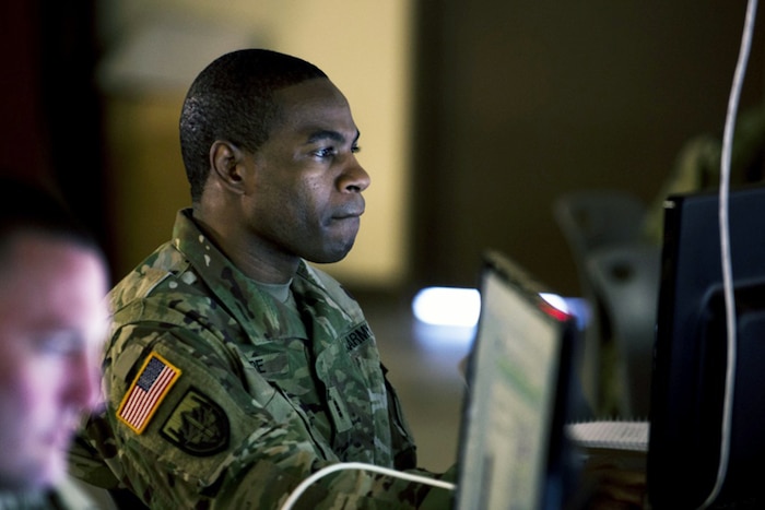 A man looks at a computer screen.