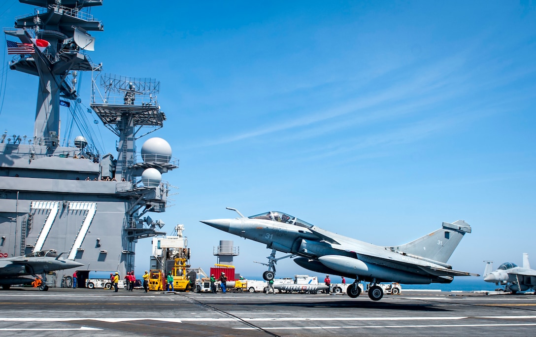 A French navy Rafale aircraft lands on the aircraft carrier USS George H.W. Bush in the Atlantic Ocean.
