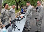 Col. Brian Barthel (right), Chief, Security Force, Air Education and Training Command, and Col. Thomas Miner (second from right), commander, 502nd Security and Readiness Group, look over some of the weapons used by 502nd Security Forces Squadron members at the opening of National Police Week at the Quadrangle at Joint Base San Antonio-Fort Sam Houston May 14.