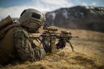 A U.S. Marine with 1st Platoon, 1st Reconnaissance Battalion, 1st Marine Division, returns fire while conducting a live fire range and patrol, during Exercise Platinum Ren, at Fort Trondennes, Harstad, Norway, May 11, 2018.