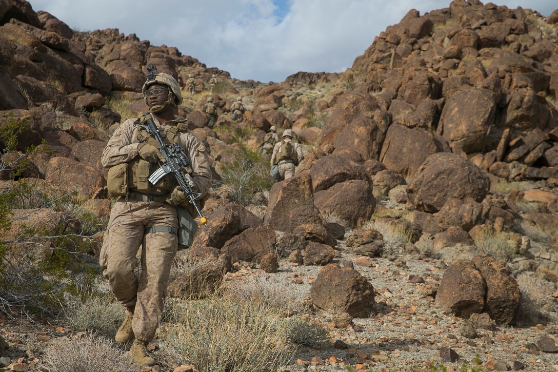 U.S. Marine Corps Lance Cpl. Peyton Ross, an infantryman with 3rd Light Armored Reconnaissance Battalion, 1st Marine Division, conducts a foot patrol during a Marine Corps Combat Readiness Evaluation (MCCRE) at Marine Corps Air Ground Combat Center, Twentynine Palms, Calif., March 12, 2018.