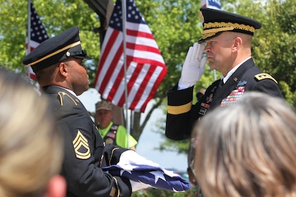 Lt. Gen. Jeffrey Buchanan (right) salutes as he is handed the folded U.S. flag by a member of the Fort Sam Houston Honor Guard May 11 at the memorial service for Army Maj. Donald G. Carr at the Fort Sam Houston National Cemetery. Buchanan is the commanding general of U.S. Army North (Fifth Army). Carr, a Green Beret, was declared missing in action after his OV-10A Bronco aircraft crashed July 6, 1971, during bad weather on a mission in Vietnam.