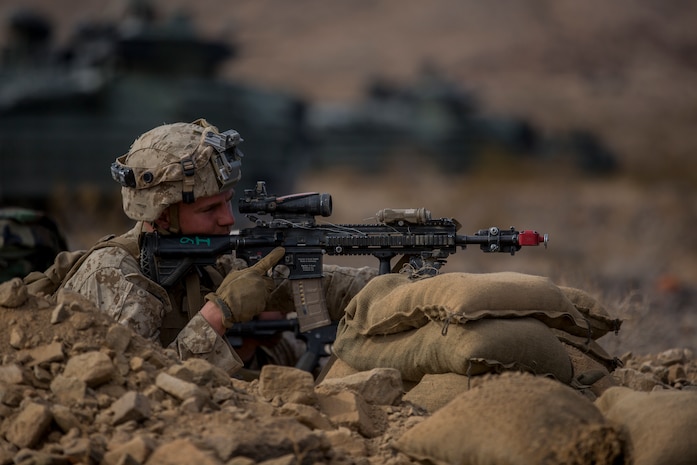 U.S. Marine Corps Lance Cpl. Jacob McLean, a rifleman with 3rd Battalion, 7th Marine Regiment, 1st Marine Division, engages the enemy during a Marine Corps Combat Readiness Evaluation (MCCRE) at Marine Corps Air Ground Combat Center, Twentynine Palms, Calif., Nov. 30, 2017.