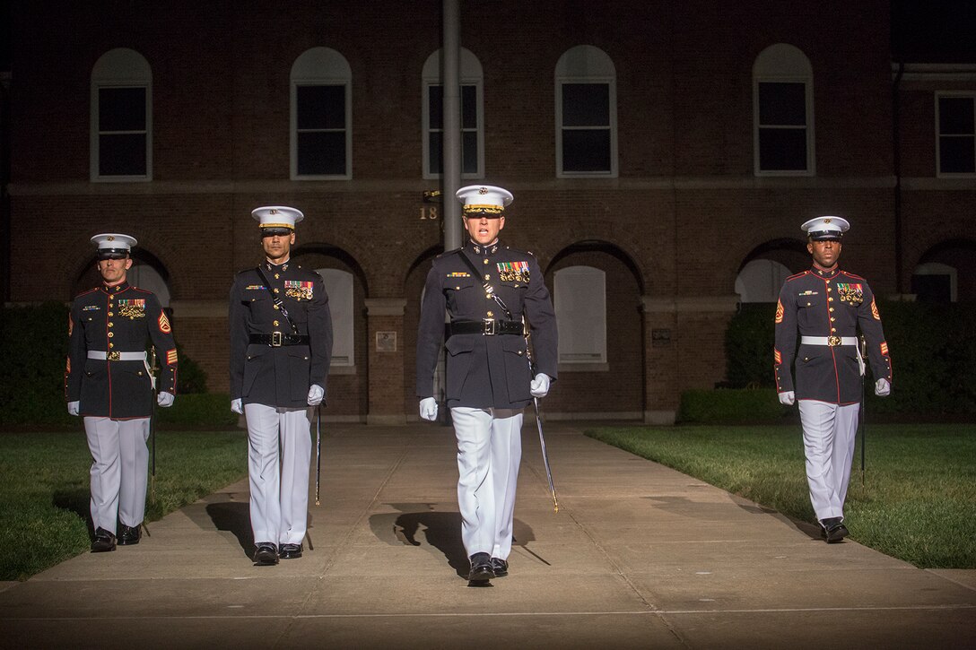 Marines with the Marine Barracks Washington D.C. parade marching staff march down Center Walk during a Friday Evening Parade at Marine Barracks Washington D.C., May 11, 2018. The guest of honor for the parade was Deputy Secretary of Defense Patrick M. Shanahan and was hosted by the Assistant Commandant of the Marine Corps, Gen. Glenn M. Walters. (Official Marine Corps photo by Cpl. Robert Knapp/Released)