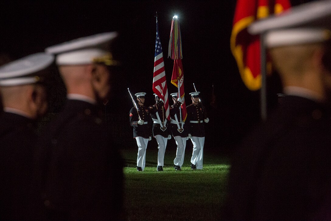 The U.S. Marine Corps Color Guard march the National Ensign and the U.S. Marine Corps Battle Colors onto the parade deck during a Friday Evening Parade at Marine Barracks Washington D.C., May 11, 2018. The guest of honor for the parade was Deputy Secretary of Defense Patrick M. Shanahan and was hosted by the Assistant Commandant of the Marine Corps, Gen. Glenn M. Walters. (Official Marine Corps photo by Cpl. Robert Knapp/Released)