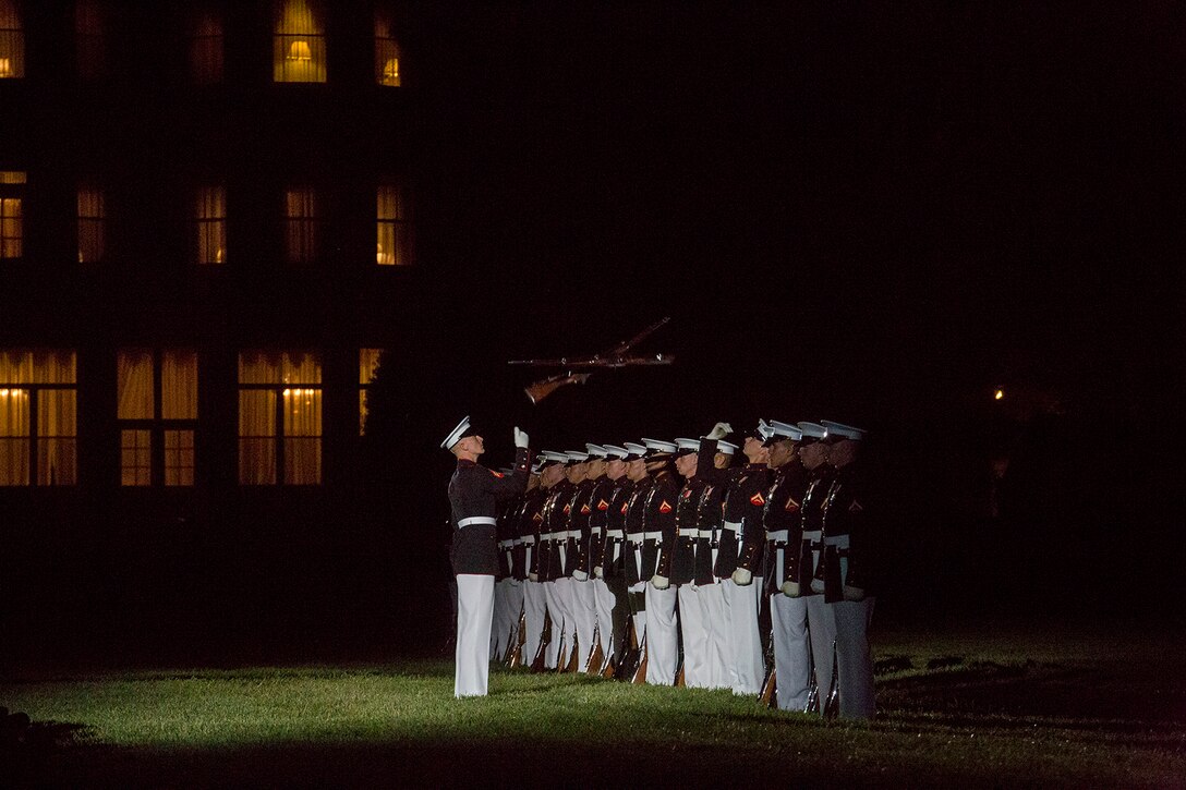 Corporal Ryan Watkins, rifle inspector, U.S. Marine Corps Silent Drill Platoon, performs precision rifle drill maneuvers during a Friday Evening Parade at Marine Barracks Washington D.C., May 11, 2018. The guest of honor for the parade was Deputy Secretary of Defense Patrick M. Shanahan and was hosted by the Assistant Commandant of the Marine Corps, Gen. Glenn M. Walters. (Official Marine Corps photo by Cpl. Robert Knapp/Released)