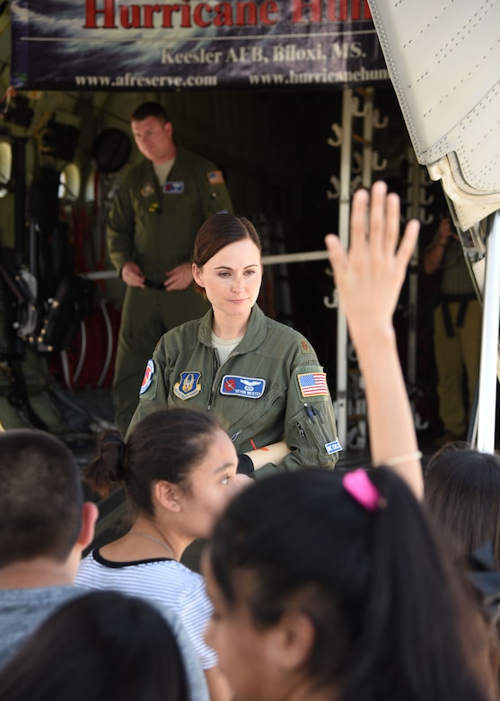 Maj. Devon Meister, 53rd Weather Reconnaissance Squadron pilot, talks to school students about the squadron's mission and how they collect weather data for National Hurricane Center forecasts during the NOAA Gulf Coast Hurricane Awareness Tour May 7, 2018, at the McAllen Miller International Airport, McAllen, Texas. The 53rd WRS, an Air Force Reserve unit in the 403rd Wing at Keesler Air Force Base, Mississippi, took part in the tour May 7-11, 2018. This is the fourth year the Hurricane Hunters participated in all five stops of the awareness and preparedness event, which was in conjunction with National Hurricane Preparedness Week. (U.S. Air Force photo/Maj. Marnee A.C. Losurdo)