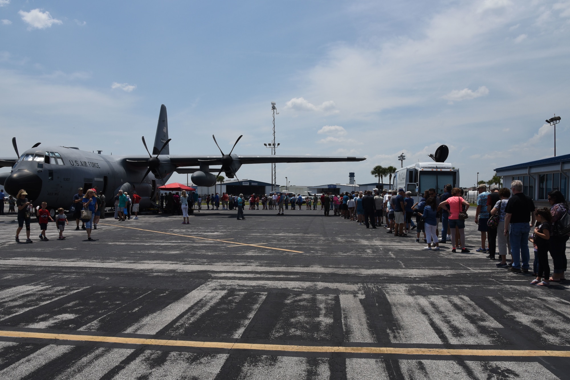 People line up at the Lakeland Linder Regional Airport, Lakeland, Florida May 11, 2018, to see the WC-130J aircraft used by the 53rd Weather Reconnaissance Squadron to collect weather data for the National Hurricane Center's forecasts. NOAA's National Weather Service and NHC has conducted the Hurricane Awareness Tour for more than 35 years; however, this is the fourth year the 53rd WRS has participated in all five stops of the awareness and preparedness event, which was in conjunction with National Hurricane Preparedness Week May 7-11, 2018. (U.S. Air Force photo/Maj. Marnee A.C. Losurdo)