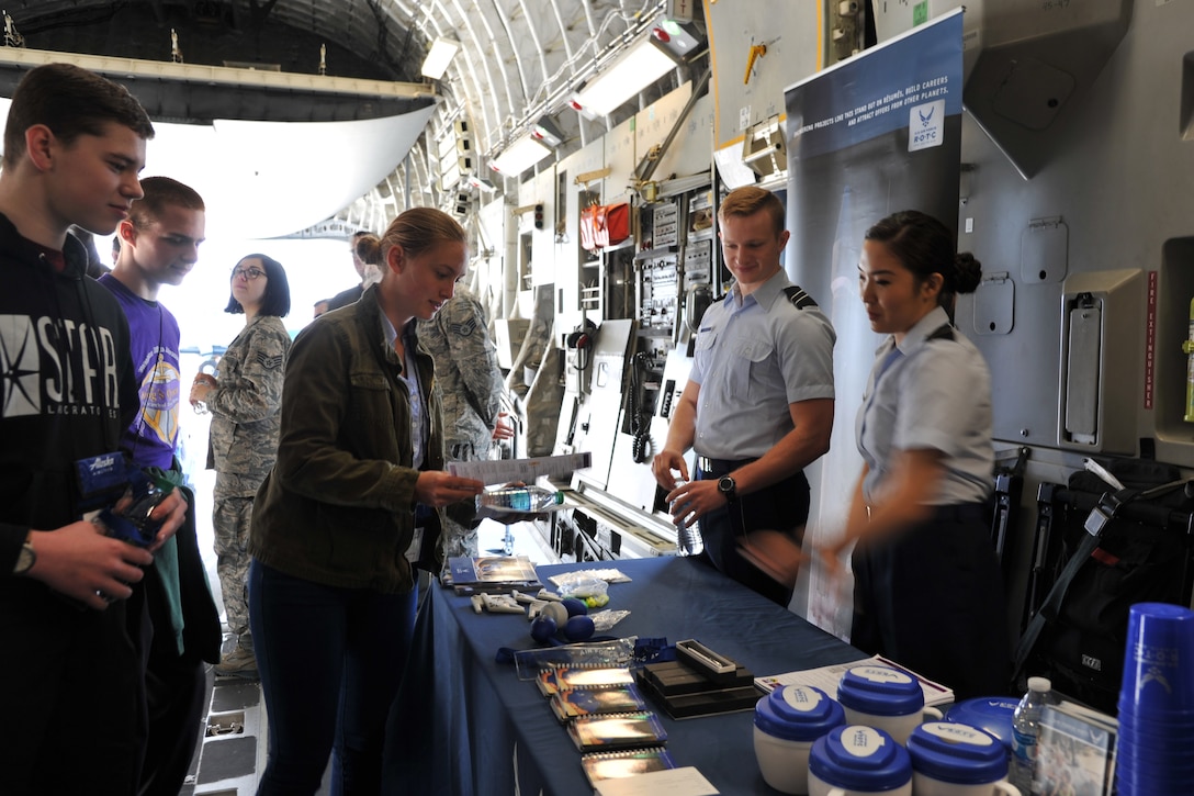 Cadets from the Air Force Reserve Officer Training Corps Detachment 910 share information with teenage students visiting the C-17 Globemaster III static display during the Alaska Airlines Aviation Day event May 5, 2018 at Seattle-Tacoma International Airport.