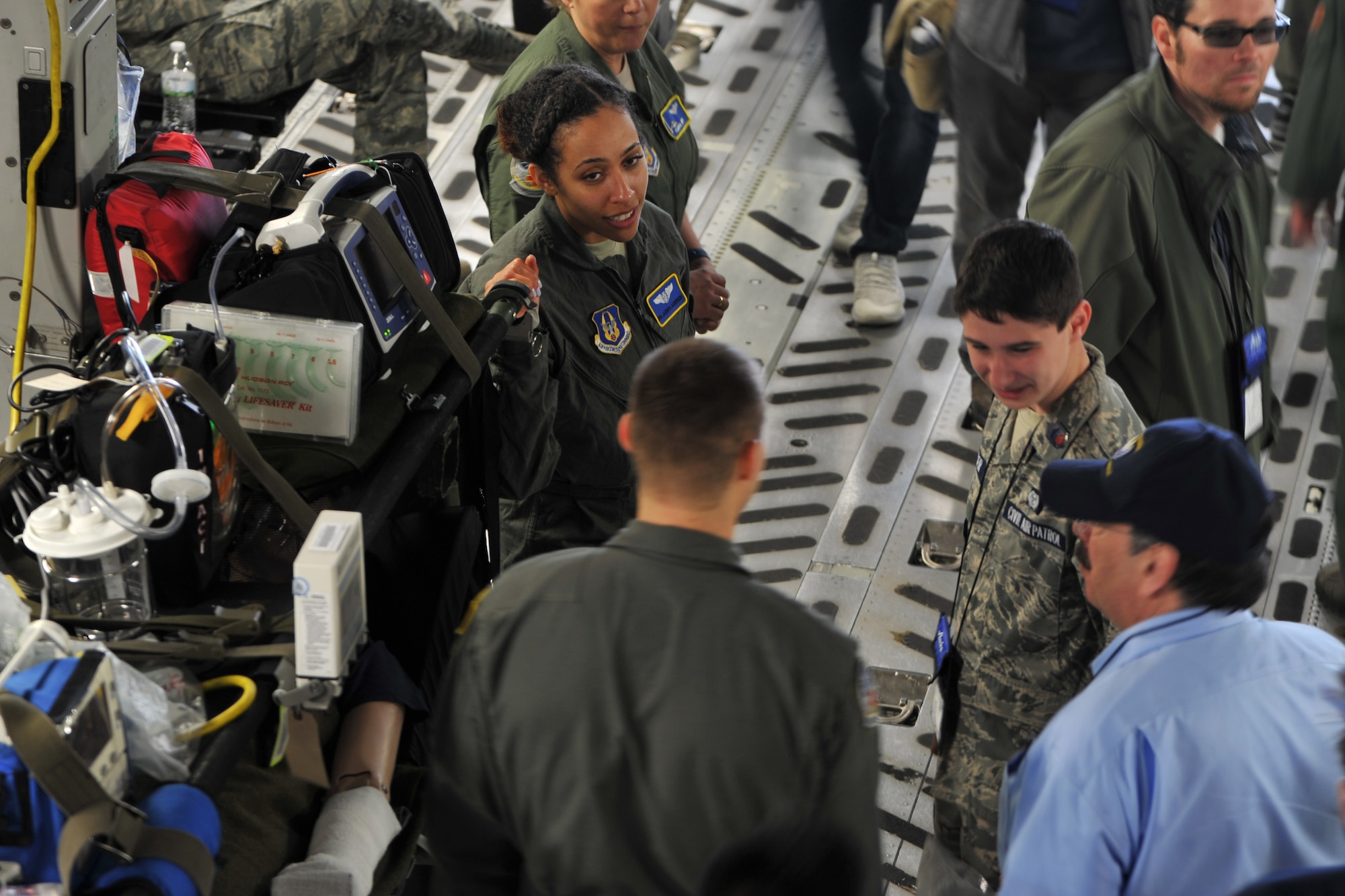 Senior Airman Jazmyn Anderson, flight medic with the 439th Aeromedical Evacuation Squadron, shares information with teenage students and chaperones visiting the C-17 Globemaster III static display during the Alaska Airlines Aviation Day event May 5, 2018 at Seattle-Tacoma International Airport.