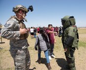 Members of the 56th Civil Engineer Squadron explosive ordnance disposal flight interact with students from L. Thomas Heck Middle School April 20, 2018, in Litchfield Park, Ariz. Together with the 56th Security Forces Squadron, Luke Airmen visited the school to thank them for their efforts in providing care packages for deployed service members and to immerse them, for a brief period of time, in military customs. (U.S. Air Force photo by Senior Airman Ridge Shan)