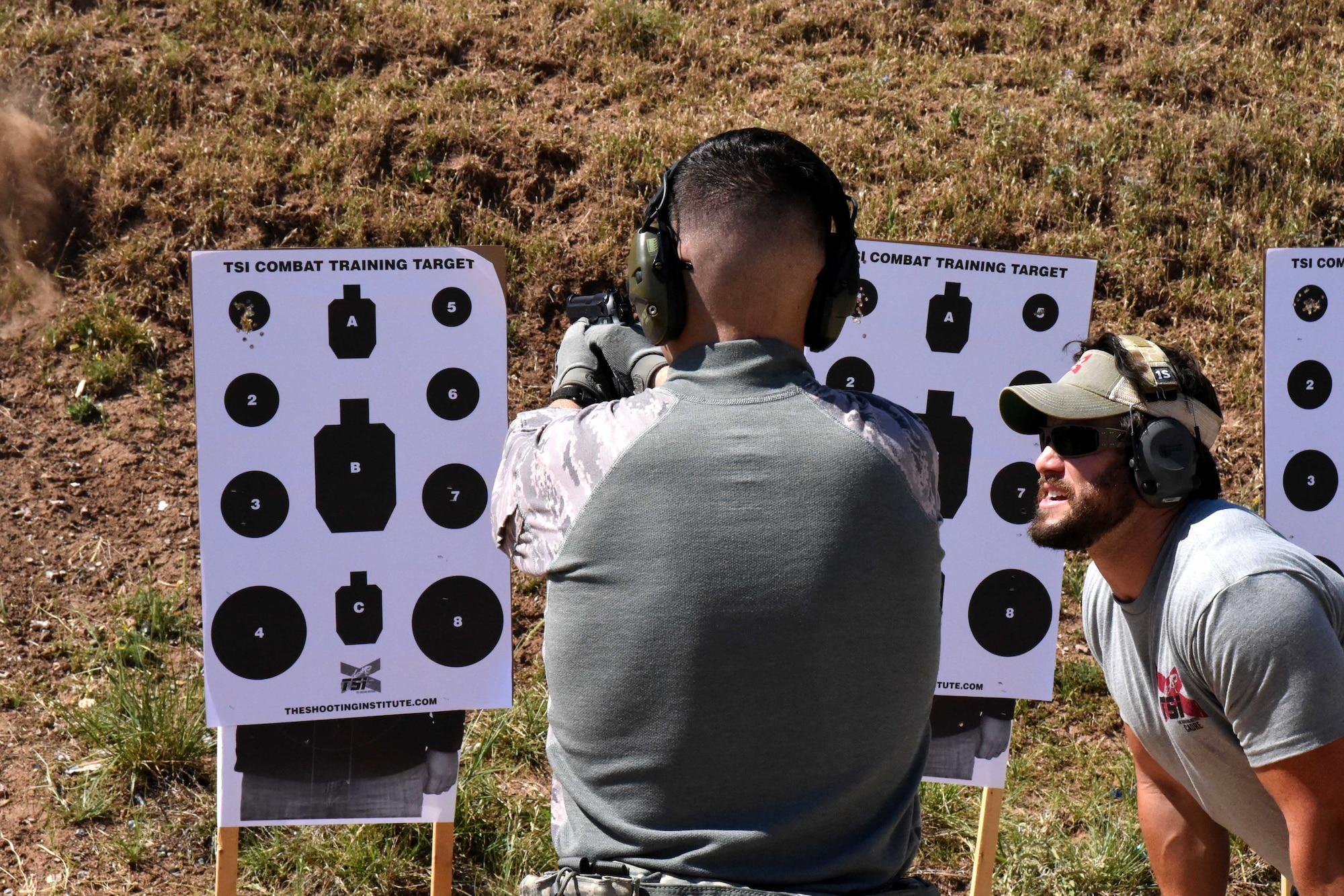 U.S. Air Force Airman Josten Lacey, 17th Security Forces Squadron defender, shoots under the instruction of The Shooting Institute chief executive officer, Jared Hudson, during the Special Weapons and Tactics and Close Quarters Combat training at the Goodfellow Air Force Base shooting range in San Angelo, Texas, May 9, 2018. Students learned how to operate their weapons inside buildings. (U.S. Air Force photo by Airman 1st Class Seraiah Hines/Released)