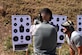 U.S. Air Force Airman Josten Lacey, 17th Security Forces Squadron defender, shoots under the instruction of The Shooting Institute chief executive officer, Jared Hudson, during the Special Weapons and Tactics and Close Quarters Combat training at the Goodfellow Air Force Base shooting range in San Angelo, Texas, May 9, 2018. Students learned how to operate their weapons inside buildings. (U.S. Air Force photo by Airman 1st Class Seraiah Hines/Released)