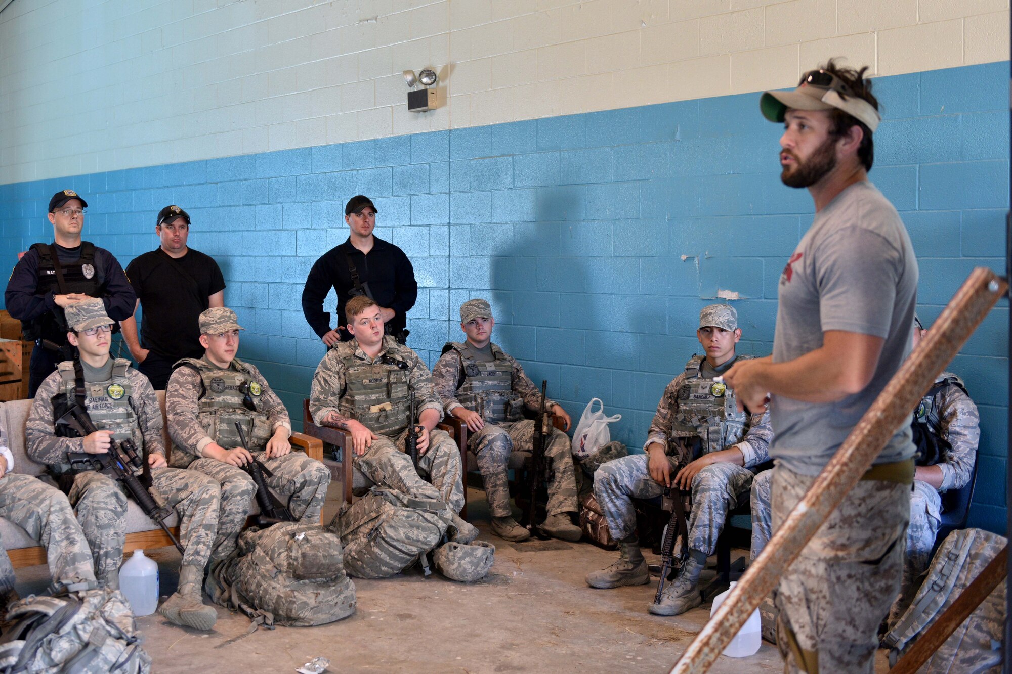 The Shooting Institute chief executive officer, Jared Hudson, briefs Goodfellow Air Force Base and Special Weapons and Tactics team members before performing maneuvers during the SWAT and Close Quarters Combat training at the Eldorado Air Force Station in Eldorado, Texas, May 10, 2018. The students learned the basics of approach, breaching, deliberate vs. dynamic movement, threat identification and how to use pistols and rifles in CQC environments. (U.S. Air Force photo by Senior Airman Randall Moose/Released)